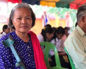 An elderly woman wearing a blue shirt