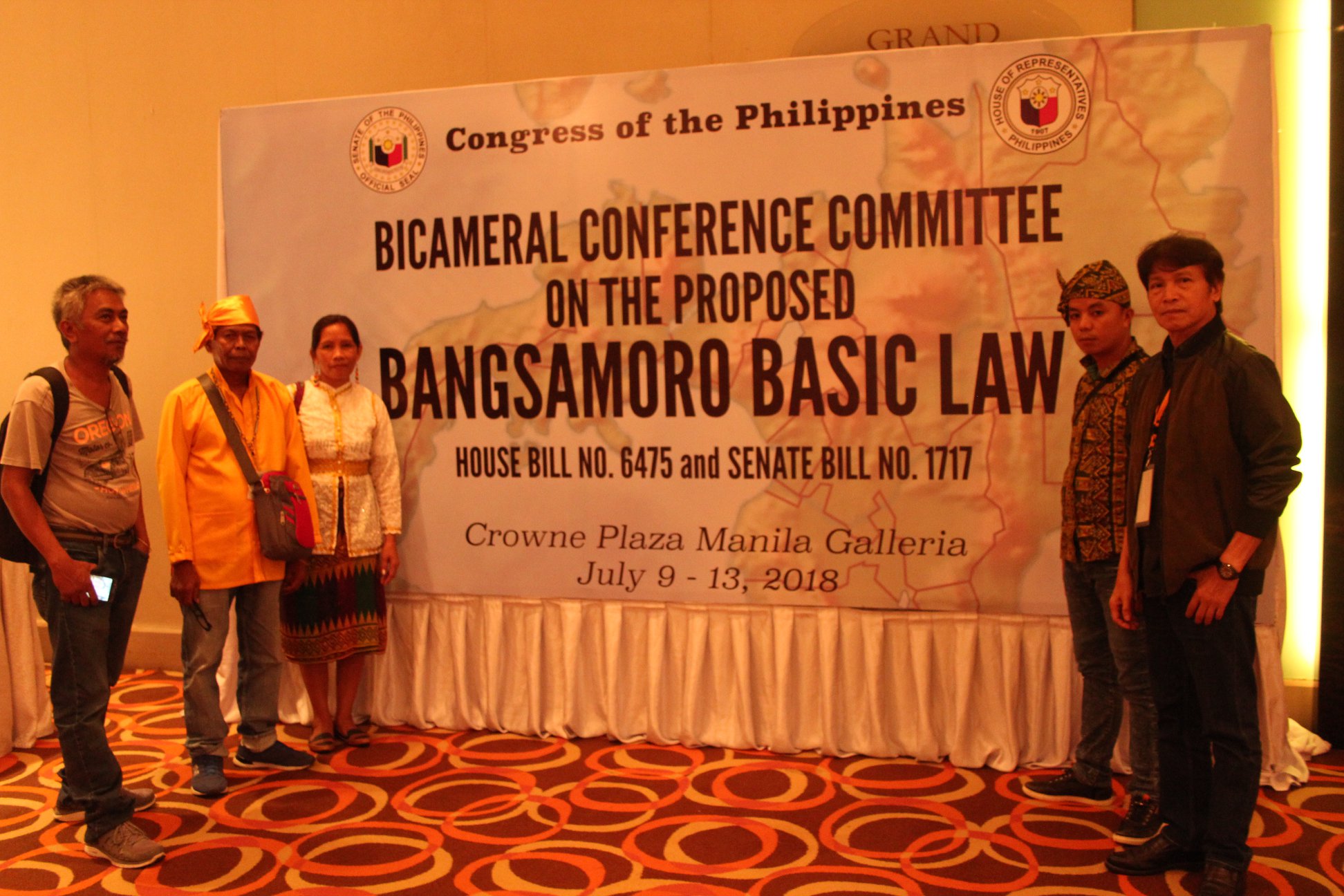 Indigenous Peoples Leaders standing in front of a banner of the Bicameral Conference Committee in the Proposed Bangsamoro Basic Law