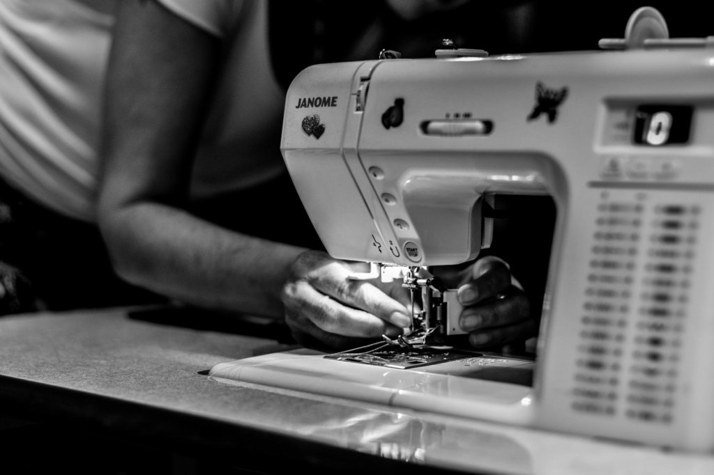 Image showing a woman using a sewing machine (Image from Pexels)