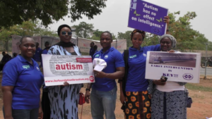 A group photo of road walk participants holding their banners/signs