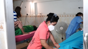 Oun Sreyda practicing Anma and Shiatsu Therapeutic Massage in the training room, July 2022