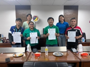A group photo of people from the Center for Youth Advocacy and Networking and the Municipal Office of Alaminos, Laguna, showing the signed ordinance establishing a Young Farmers Council