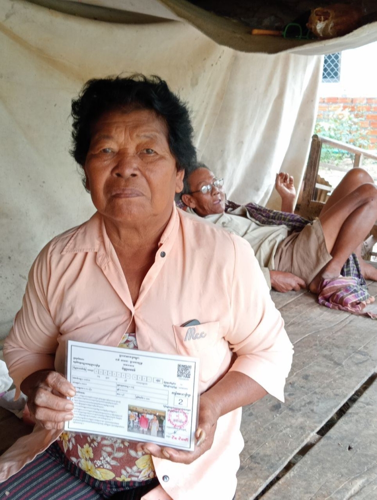 Ms. Chab Reurn showing her husband's health card