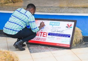 Stakeholders signing a plaque vowing to fight against gender-based violence
